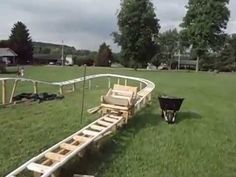 a wooden sled in the middle of a grassy field