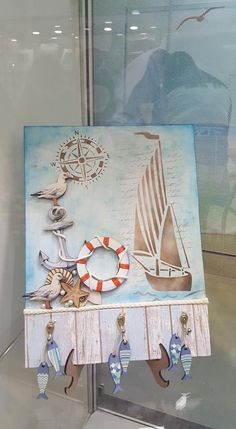 an art piece is displayed in a glass case with seagulls and boats on it