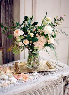 a vase filled with flowers sitting on top of a table