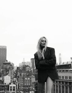 a woman standing on top of a tall building