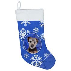 a blue christmas stocking with a photo of a dog on it and snowflakes