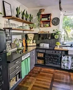 a kitchen with lots of pots and pans on the stove top, shelves above