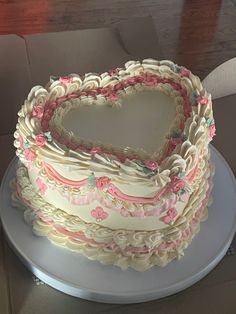 a heart shaped cake sitting on top of a white plate