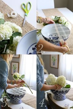 a woman is arranging flowers in a blue and white bowl