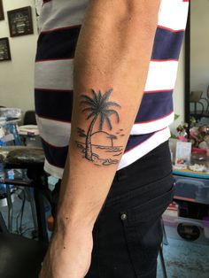 a man with a palm tree tattoo on his arm