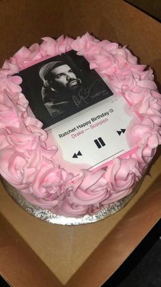 a cake with pink icing on it in a box