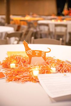 an orange and white table topped with paper animals