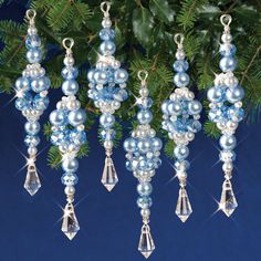 blue and white beaded ornaments hanging from a christmas tree