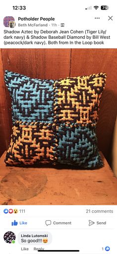 two blue and yellow pillows sitting on top of a wooden chair next to each other