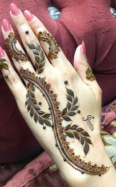 a woman's hand is decorated with hennap and flowers on it,