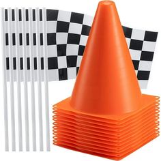 an orange traffic cone next to several black and white checkered flags on a white background