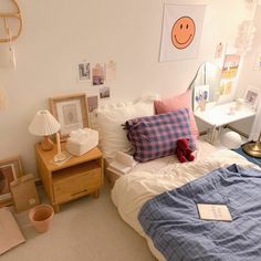 a bedroom with a bed, nightstands and pictures on the wall above it is shown