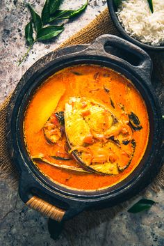 an overhead view of a bowl of curry and rice