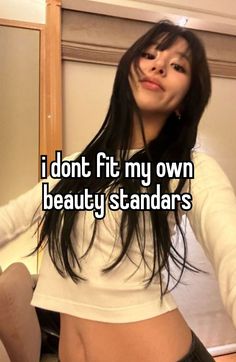 a girl with long black hair and white shirt is standing in front of a mirror