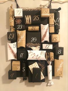 a clock made out of wrapped presents and numbers on the front of it, hanging from a wall