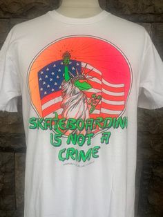 "Vintage 90s Skateboarding Is Not A Crime T-shirt Item Condition: Pre-Owned (Used) condition. please see pictures Size on Tag: L, Please check measurement Tag : Hanes ------------ Measurement: ------------- Chest (Pit to Pit) 20\" Length 28\" Shipping: Worldwide ---------- Standard Shipping 14-30 Days Express 5-8 Days I can do combined shipping +Add USD 5 shipping for each additional items!" Graphic Tee T-shirt With Graffiti Print For Skateboarding, 90s Skateboarding Letter Print T-shirt, 90s Letter Print T-shirt For Skateboarding, Graphic Tee For Skateboarding In Summer, Summer Graphic Tee For Skateboarding, White Urban T-shirt For Skateboarding, Urban Style White T-shirt For Skateboarding, Casual T-shirt With Graphic Print For Snowboarding, Casual Crew Neck T-shirt For Snowboarding