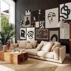 a living room filled with furniture and pictures on the wall