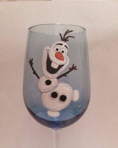 a wine glass with an image of the character frozen water painted on it's side