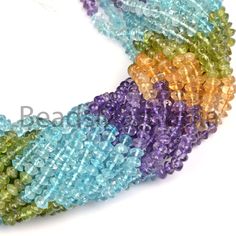 multicolored glass beads are arranged on a white surface