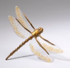 a gold and white dragon figurine sitting on top of a table