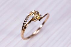 Gold ring (14k) with Citrine. Type of good: Ring Stone: Citrine Metal: Gold 585o (14K) Average weight: 2,89 gr. : * If desired, we can replace the main gem with any of the following: Amethyst, Alexandrite, Citrine, Emerald, Garnet, London Blue Topaz, Sky Topaz, Peridot, Smoky Quartz, Sapphire, Ruby. * If the required gem stone is not on the list, feel free to let us know which of the precious stones you would like to be set in * If you prefer, this piece of jewelry can be made with sterling silv 14k Yellow Gold Topaz Ring With Rose Cut Diamonds, 14k Gold Crystal Ring With Diamond Cut, Wedding Yellow Gold Citrine Diamond Ring, 14k Yellow Gold Crystal Promise Ring, Delicate 14k Yellow Gold Sapphire Ring, 14k Yellow Gold Topaz Promise Ring, 14k Yellow Gold Crystal Ring For Anniversary, 14k Gold Diamond Cut Bypass Ring As Gift, 14k Gold Bypass Ring With Diamond Cut