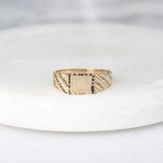 This ring features a rectangle, brushed gold center signet (perfect for engraving) with a diamond cut rectangle outer layer and yellow gold band with diamond-cut stripes on the shoulders. Perfect for everyday wear, this ring would make a great customizable gift for any occasion! Metals: 10k yellow gold rectangle center signet (approx. 6 x 5 mm)  10k yellow gold band 1.7 - 1.85 g Please allow up to 5 business days for processing. Currently only shipping within Canada and the US. | c u r a t e d | Visit our website for curated and modern pieces  https://www.menkduke.com | f a c e b o o k | Follow us on Facebook for new item announcements and discounts  https://www.facebook.com/menkDUKE/ | i n s t a g r a m | Follow us on instagram to see what we're up to @menkDUKE Yellow Gold Rectangular Engraved Promise Ring, Yellow Gold Engraved Rectangular Ring, Engraved Rectangular Yellow Gold Promise Ring, Rectangular Yellow Gold Engraved Promise Ring, Modern 14k Gold Rectangular Engraved Ring, Modern 14k Gold Engraved Rectangular Ring, Gold Minimalist Engraved Rectangular Ring, Modern Gold Rectangular Engraved Ring, Minimalist Gold Engraved Rectangular Ring