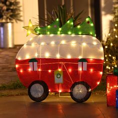 a red and white trailer with christmas lights on it