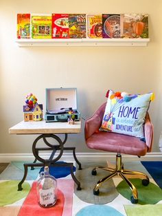 two chairs and a table in a room with colorful rugs on the floor next to each other