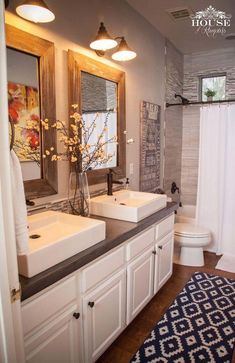 a bathroom with two sinks and a rug on the floor in front of the sink