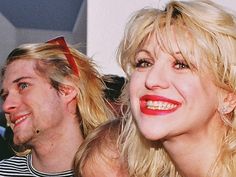 two people are posing for the camera with one woman's hair blowing in the wind