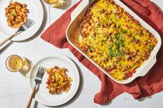 a casserole dish with meat, cheese and vegetables in it on a red napkin