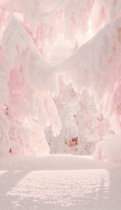 a pink and white background with snow on the ground in front of some snowy mountains