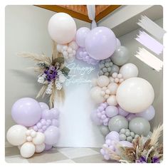 balloons and flowers are arranged in the shape of a arch