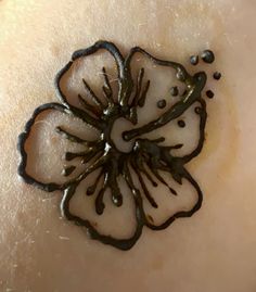 a close up of a person's skin with black and white flowers on it