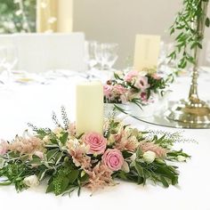 a table with flowers and candles on it