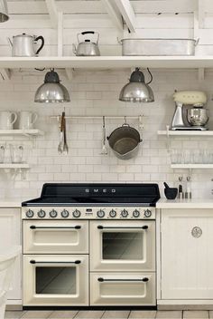 a kitchen with an oven, stove and shelves