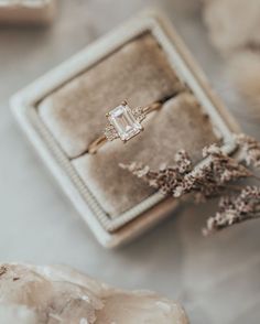 an engagement ring sitting on top of a box