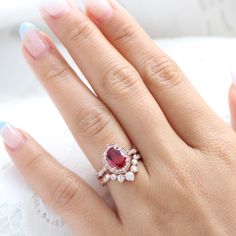 Breathtakingly unique ruby bridal ring set features an oval-shaped large ruby engagement ring set in the vintage floral diamond ring setting. To complete the one-of-a-kind look, a large 7 diamond u-shaped scalloped wedding band is created! This oval ruby and diamond ring bridal set can be made in white, yellow, rose gold, or platinum. ** The hand model's ring size is US ring size 6.25 Jewelry Information Engagement Ring: Center Stone:* Conflict Free Cultured Ruby (lab grown in the USA by Chatham Oval Rose Gold Ruby Ring With Rose Cut Diamonds, Stackable Rose Gold Ruby Ring For Wedding, Oval Lab-created Ruby Wedding Jewelry, Oval Lab-created Ruby Fine Jewelry For Wedding, Oval Ruby Stackable Wedding Rings, Oval Ruby Stackable Rings For Wedding, Wedding Rings With Rose Cut Diamonds And Lab-created Ruby, Luxury Oval Rings With Rose Cut Diamonds And Ruby, Oval Rose Gold Ruby Ring For Wedding