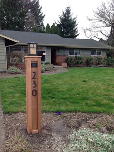 a mailbox in front of a house with the number 350 on it's side