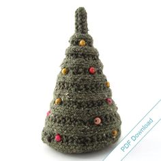 a crocheted christmas tree ornament on a white background