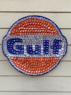 the chicago cubs logo is made out of bottle caps and glass bottles on a wall