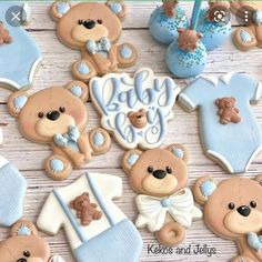 baby shower cookies with teddy bears and blue onesuits on a white tablecloth