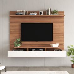 an entertainment center with a flat screen tv mounted on the wall