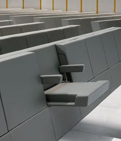 an airplane seat with the door open to show it's arm rest and storage compartment