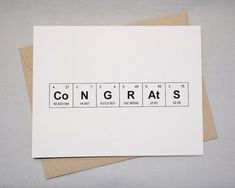 a card with the word congrats written in black and white letters on it