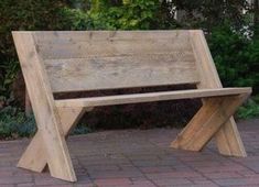 a wooden bench sitting on top of a brick walkway