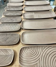 there are many plates on the table ready to be put in the oven or dishwasher