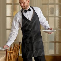 Pairing a sleek silhouette with a sophisticated black and white pinstripe pattern, this Choice black and white pinstripe adjustable tuxedo apron with 2 pockets is perfect for chic restaurants, resorts, cruise ships, and catered events. This apron ensures a crisp and uniform appearance for your staff. The easy to use taber buckle neck-strap adjustment allows a comfortable fit for any staff member and will add a tailored appearance by eliminating bunching, knotting, and trailing that comes from im Waitress Uniform Vintage, Employee Clothes, Pinstripe Tuxedo, Waiter Outfit, Malt Shop, Boutique Cafe, Restaurant Staff, Ship Ideas, Waiter Uniform