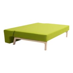 a small green ottoman sitting on top of a white table