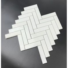 several pieces of white tile laid on top of each other with lines drawn across them